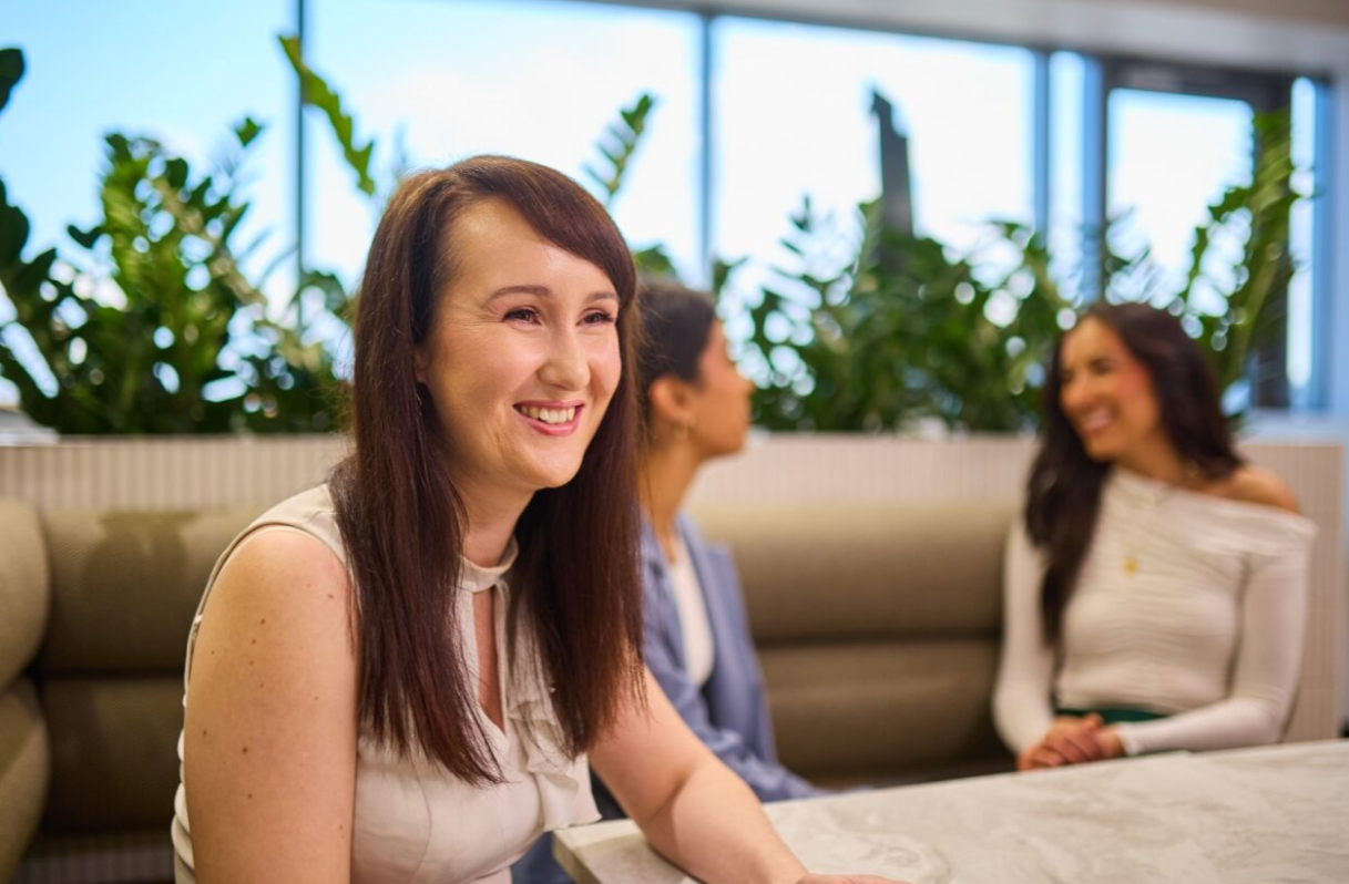 Clients engaging in discussion at a modern office, representing personal injury and employment law services in Brisbane.
