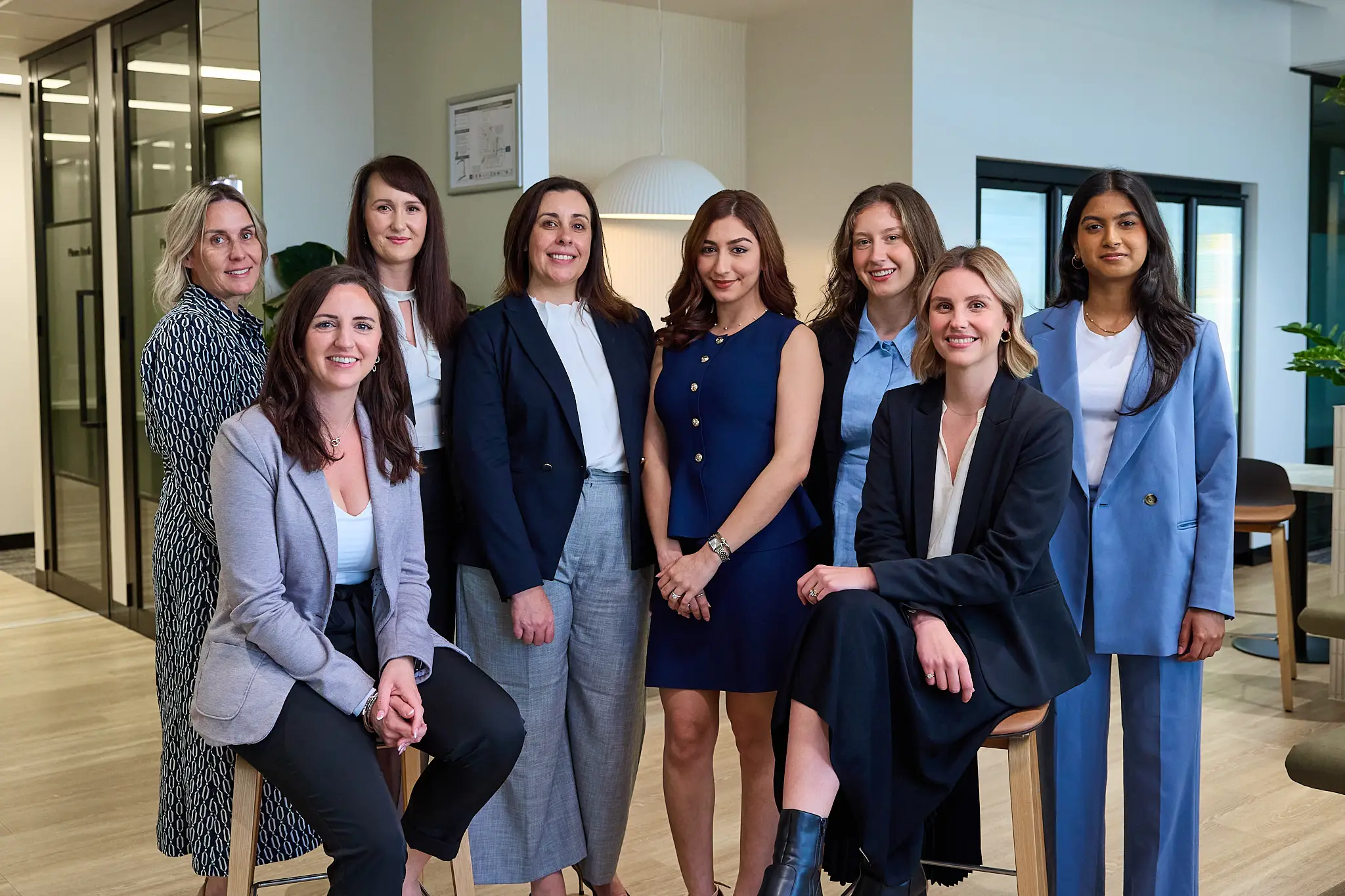 Richardson & Lyons legal team gathers in a modern office, representing expertise and dedication to clients.
